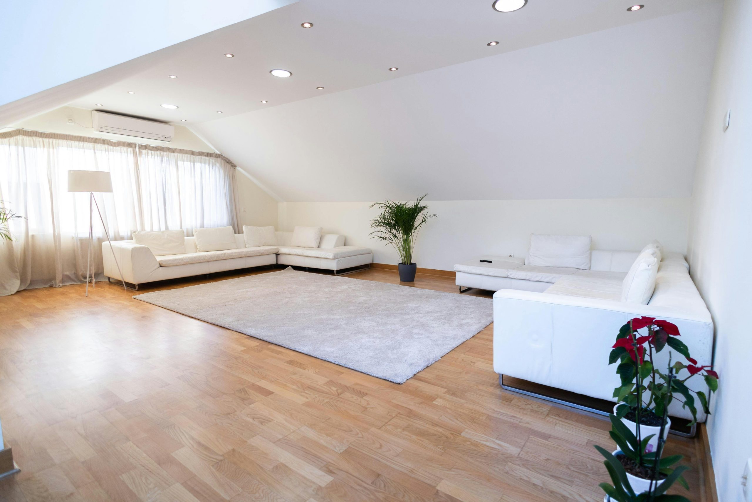 Bright Attic Oasis with Crisp White Sectionals