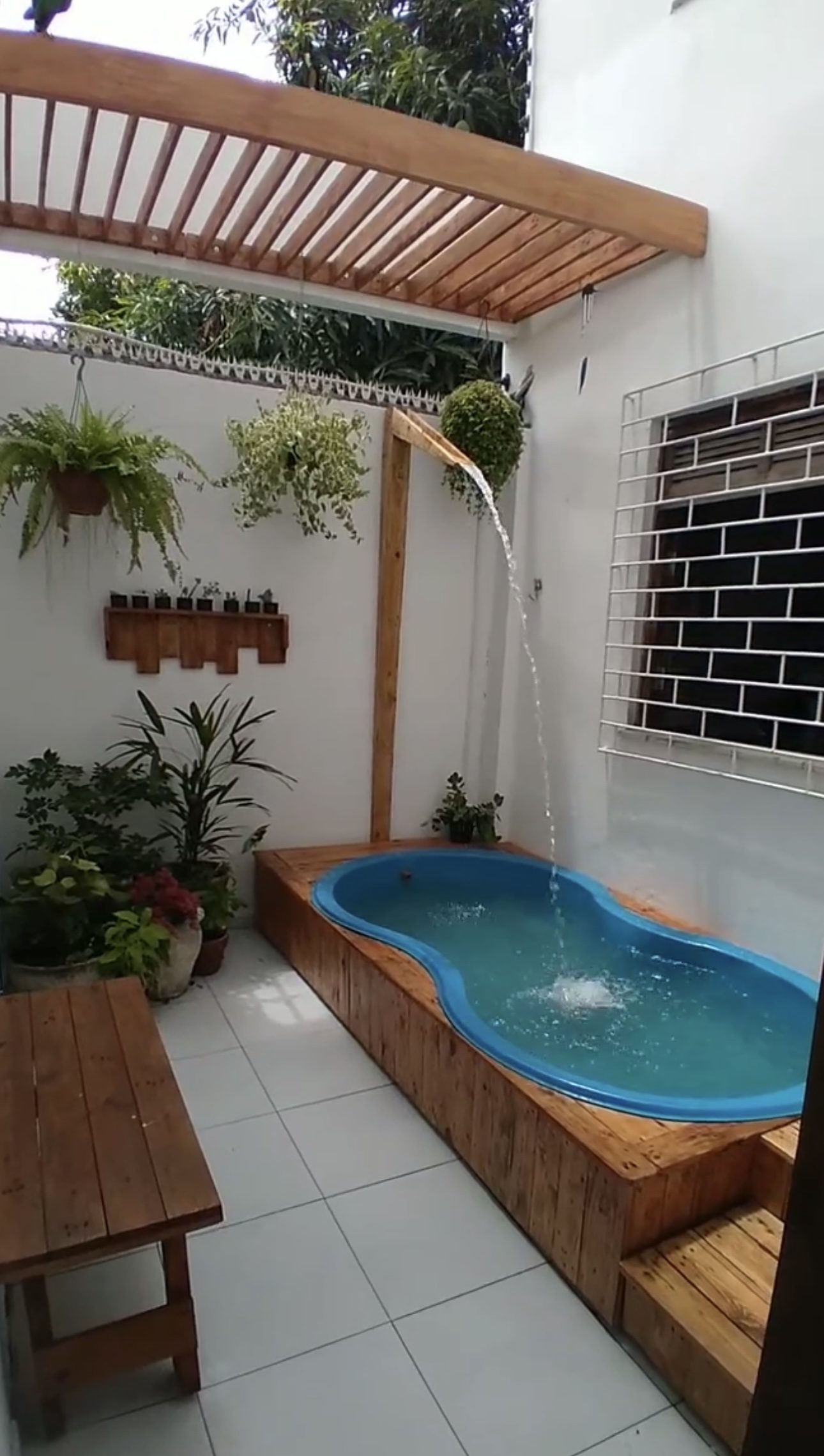Sleek Curved Oasis Featuring an Outdoor Shower