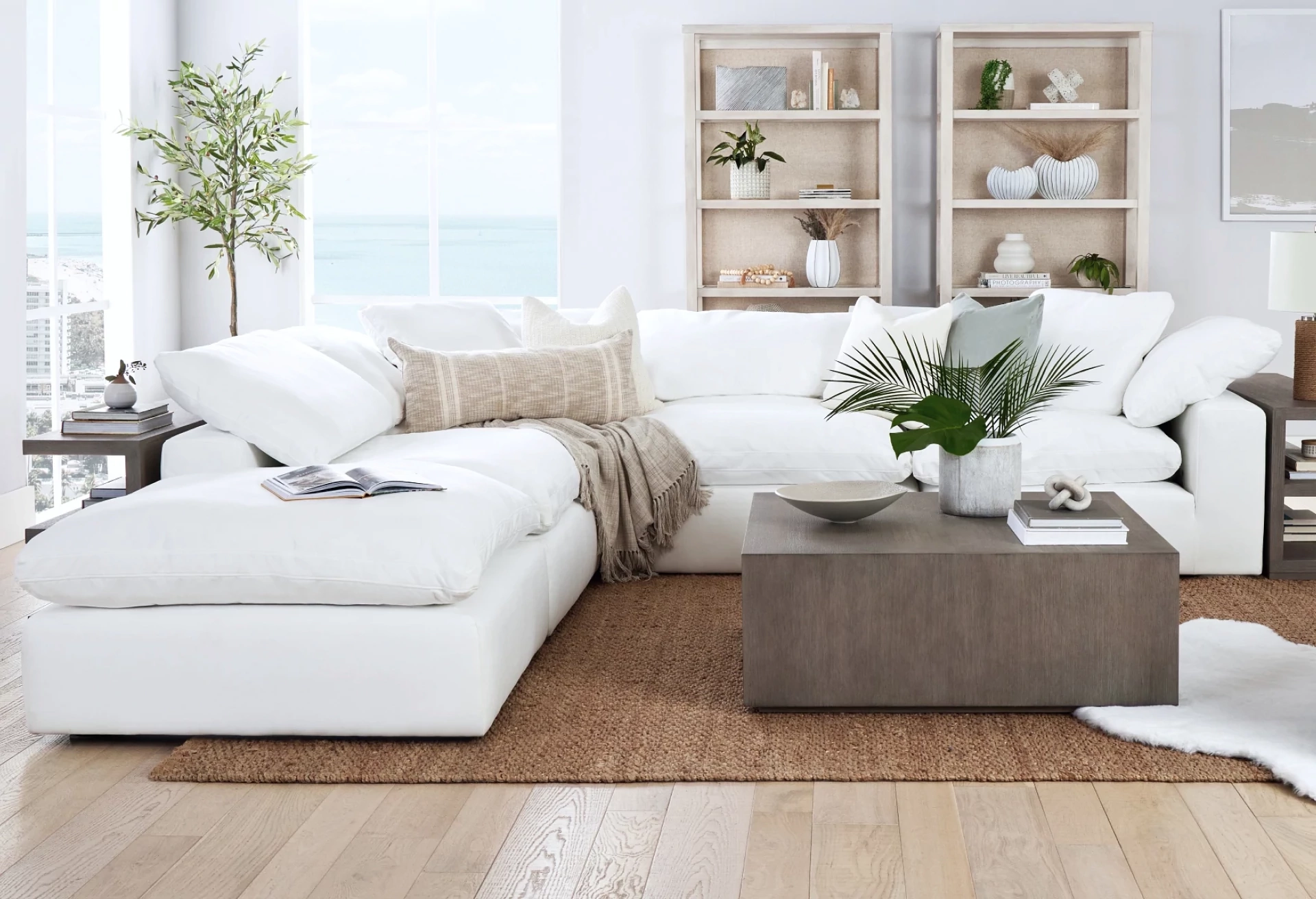 Coastal Serenity with a White Sectional, Natural Textures, and Plush Accents