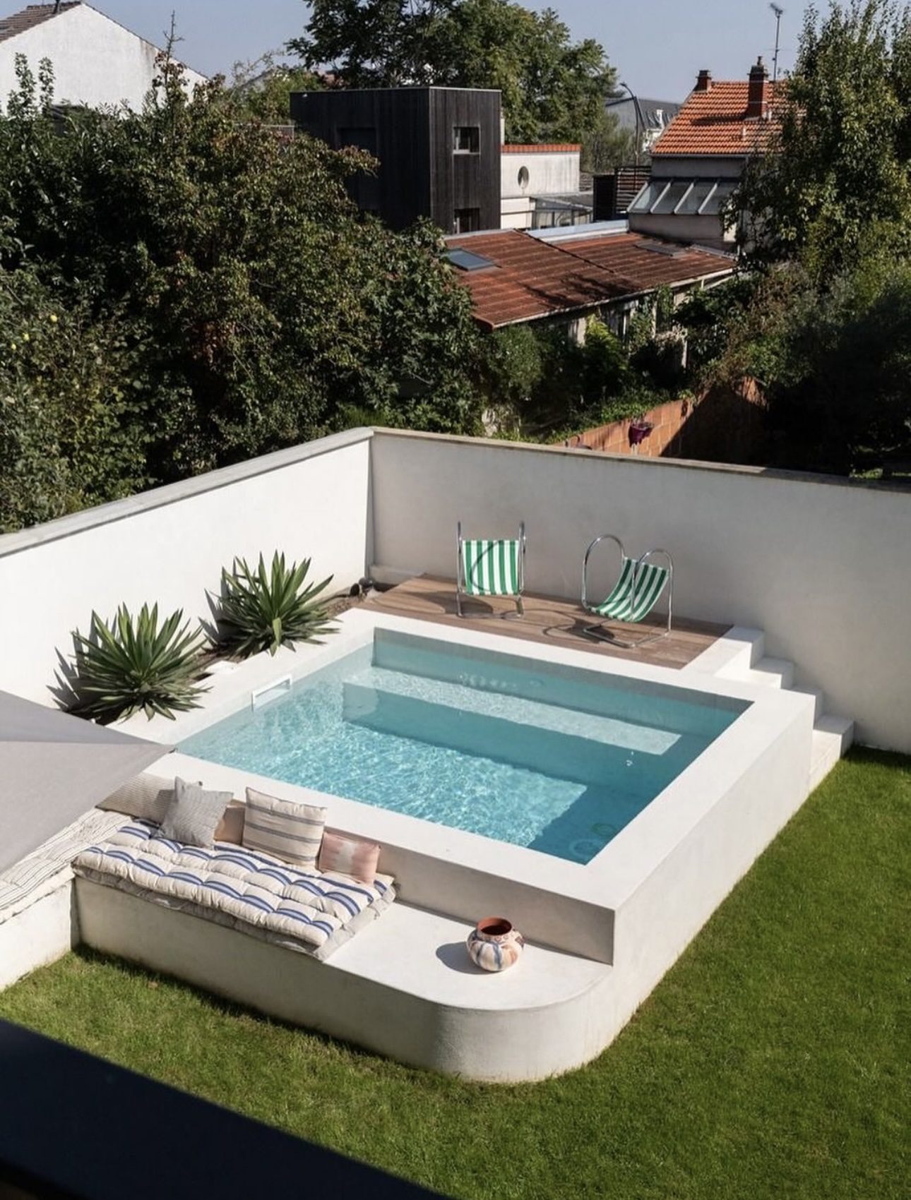 Elevated Angular Pool Featuring Integrated Loungers