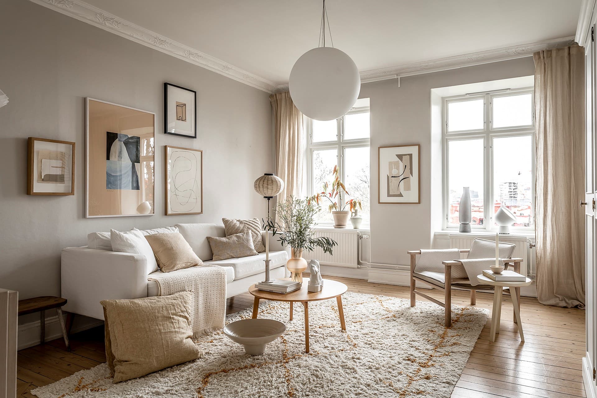 Serene Neutrals Featuring a White Sofa and Statement Pendant