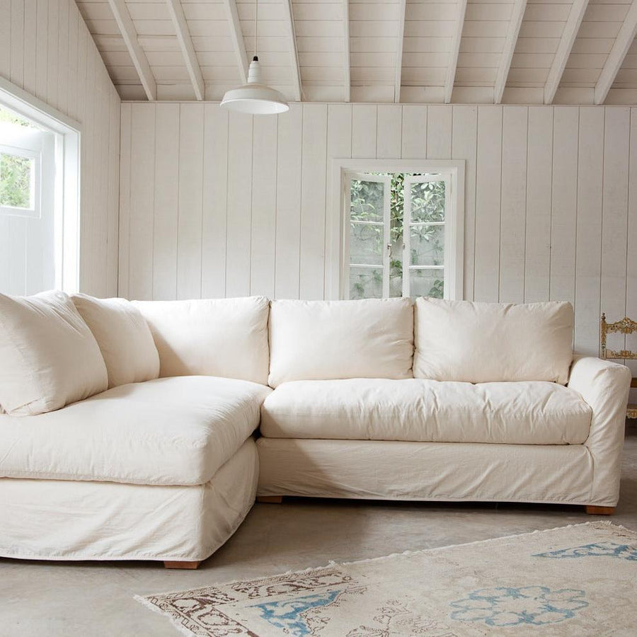 Bright White Sectional Meets Rustic Industrial Elegance with Concrete & Beams