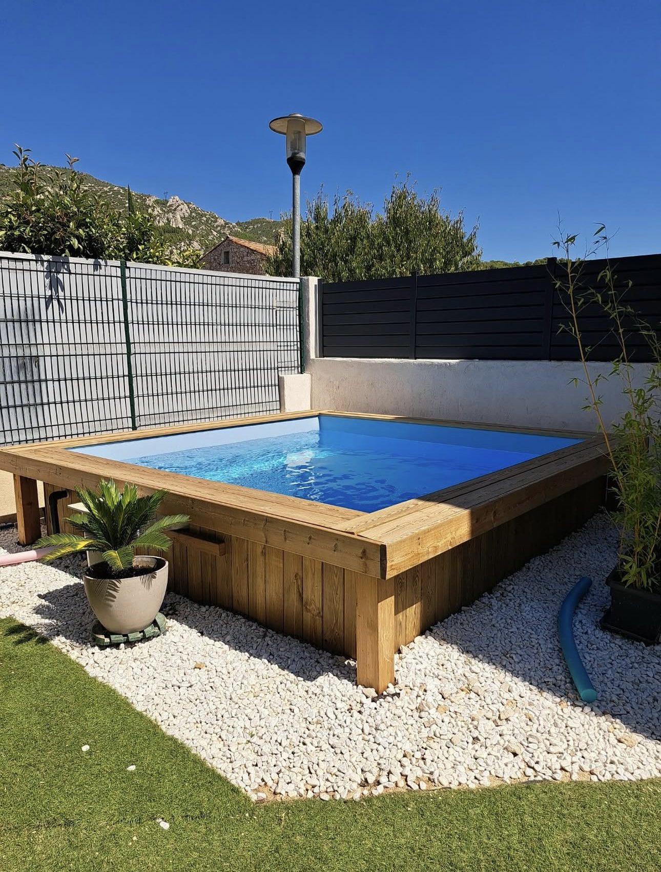 Elevated Square Pool Framed by Wood Accents