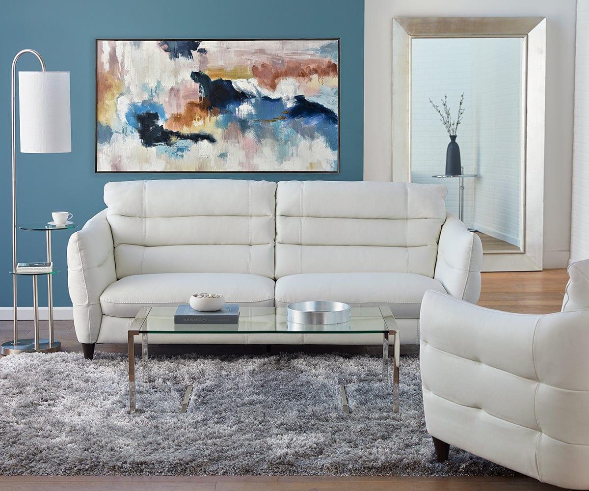 Crisp White Tufted Leather Sofa Meets Bold Teal Backdrop and Vibrant Abstract Art